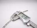 Close-up of a digital caliper measuring a link of the Gucci 3900L's bracelet, showing a width of 12.36mm.