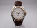 Front view of Tissot PR 50 two-tone watch with white roman numeral dial and brown leather strap.