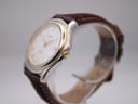 Side angle view of Tissot PR 50 watch showing the gold PVD bezel and crown, with brown leather strap.