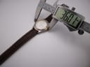 Digital caliper measuring the Tissot PR 50 watch case, displaying a diameter of 36.01mm.