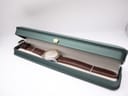 Tissot PR 50 watch with brown leather strap displayed within a dark green watch presentation box.