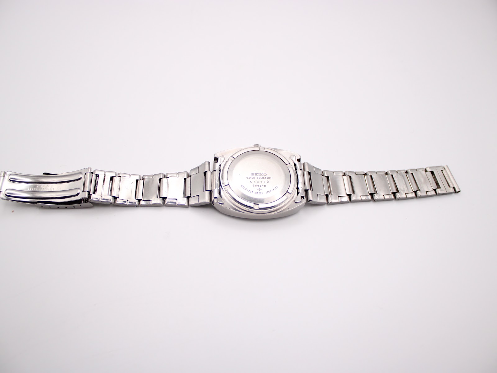 Full length back view of the Seiko 7006-5070 watch, showing the case back engraving and the integrated bracelet.