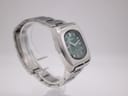 Angled view of the Seiko 7006-5070 watch, highlighting the case shape and bracelet, on a clear display stand.
