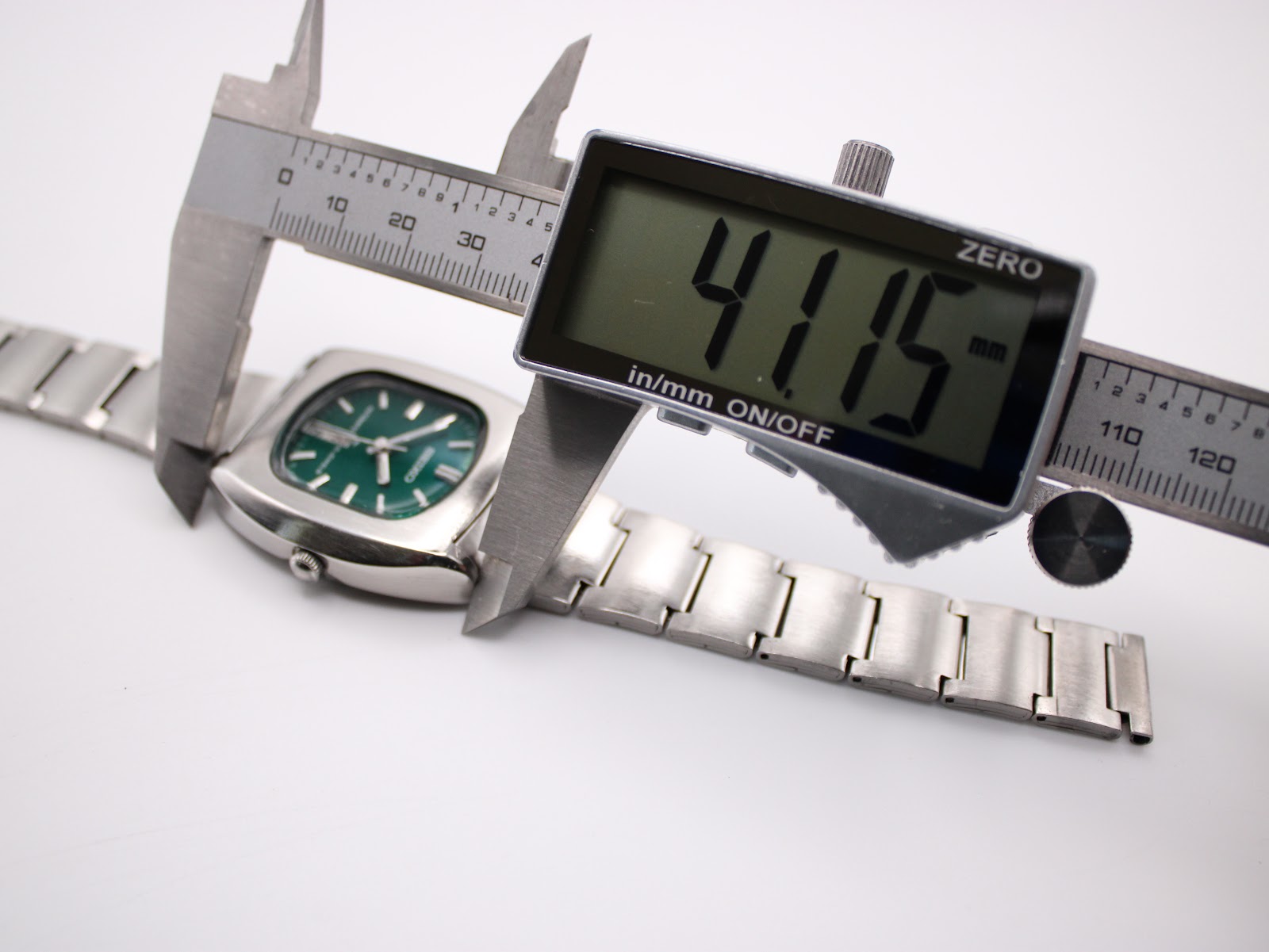 Digital caliper measuring the lug-to-lug length of the Seiko 7006-5070 case, showing a reading of 41.15 mm.