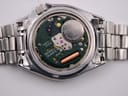 Detailed view of the open case back, revealing the Seiko four-jewel quartz movement with a Renata 390 battery.