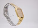 Another angled side view of the gold tone Seiko 6531-5170 watch on a clear display stand.