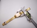 Digital caliper measuring the case diameter of the gold tone Seiko watch, displaying a precise reading of 27.88mm.