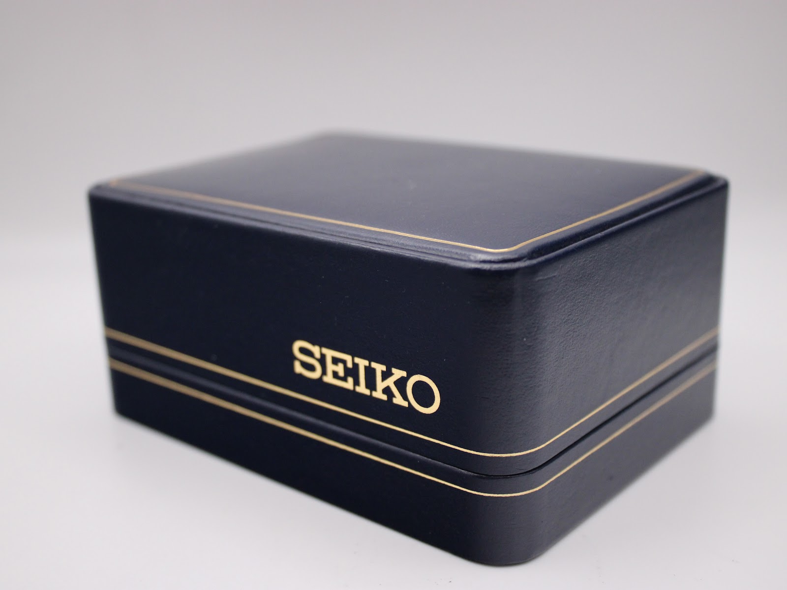 Close-up of the dark blue original Seiko presentation box with gold coloured 'SEIKO' logo.