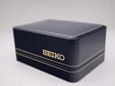 Close-up of the dark blue original Seiko presentation box with gold coloured 'SEIKO' logo.