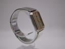 Another angled side profile of the Seiko 2A32-5060 watch on a stand, showing the crown and the two-tone integrated stainless steel bracelet.