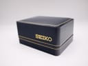 Exterior view of the original Seiko navy presentation box, featuring the gold-coloured 'SEIKO' logo and trim on the lid.