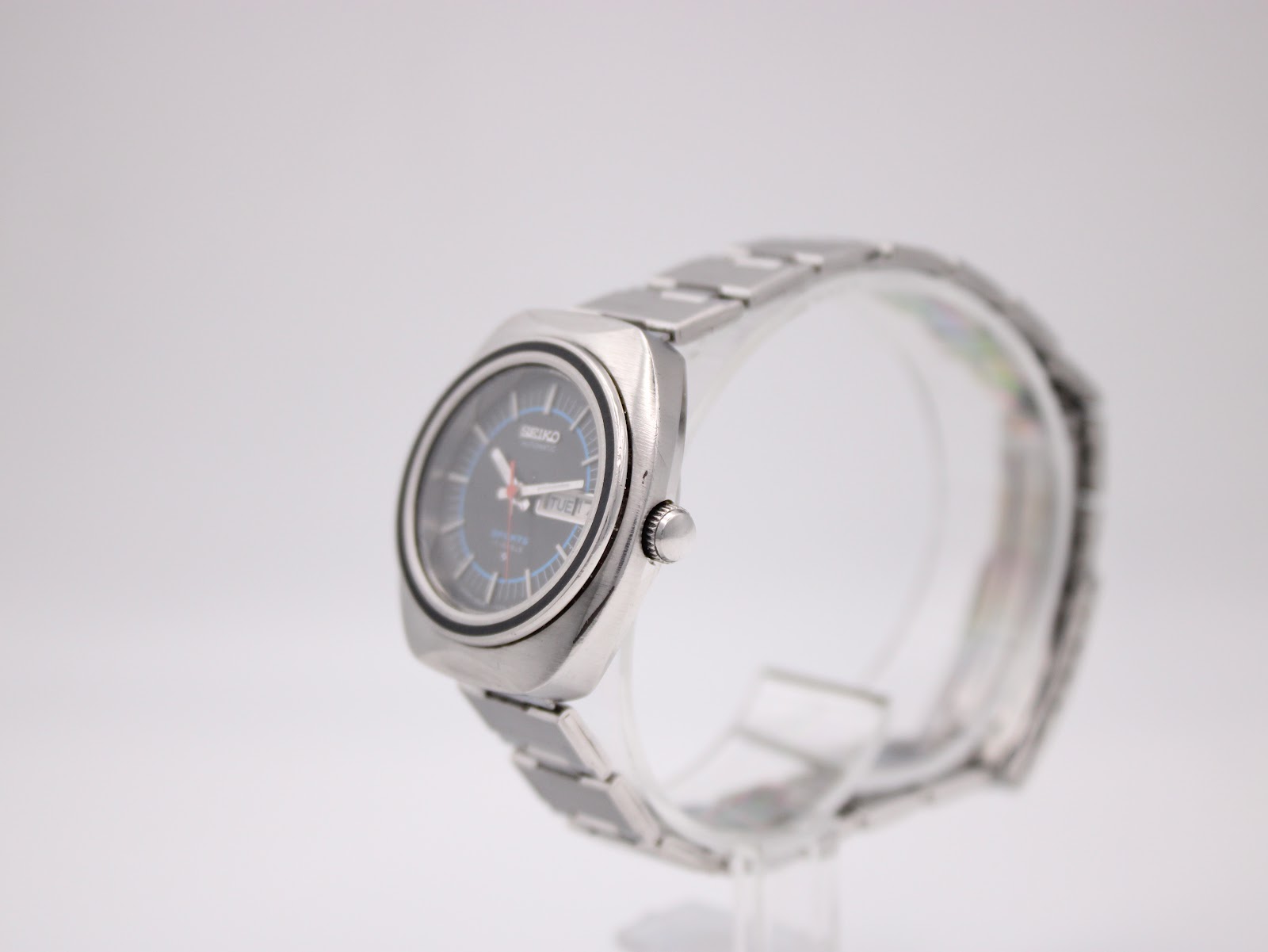 Close-up of Seiko signed folding clasp on stainless steel bracelet showing brushed finish and stamped Seiko logo