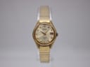 Vintage Seiko watch with gold-tone expanding bracelet resting in its original blue and wood presentation box.