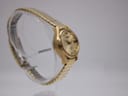 Another side view of the gold-tone Seiko automatic watch, highlighting the case shape and expanding bracelet.