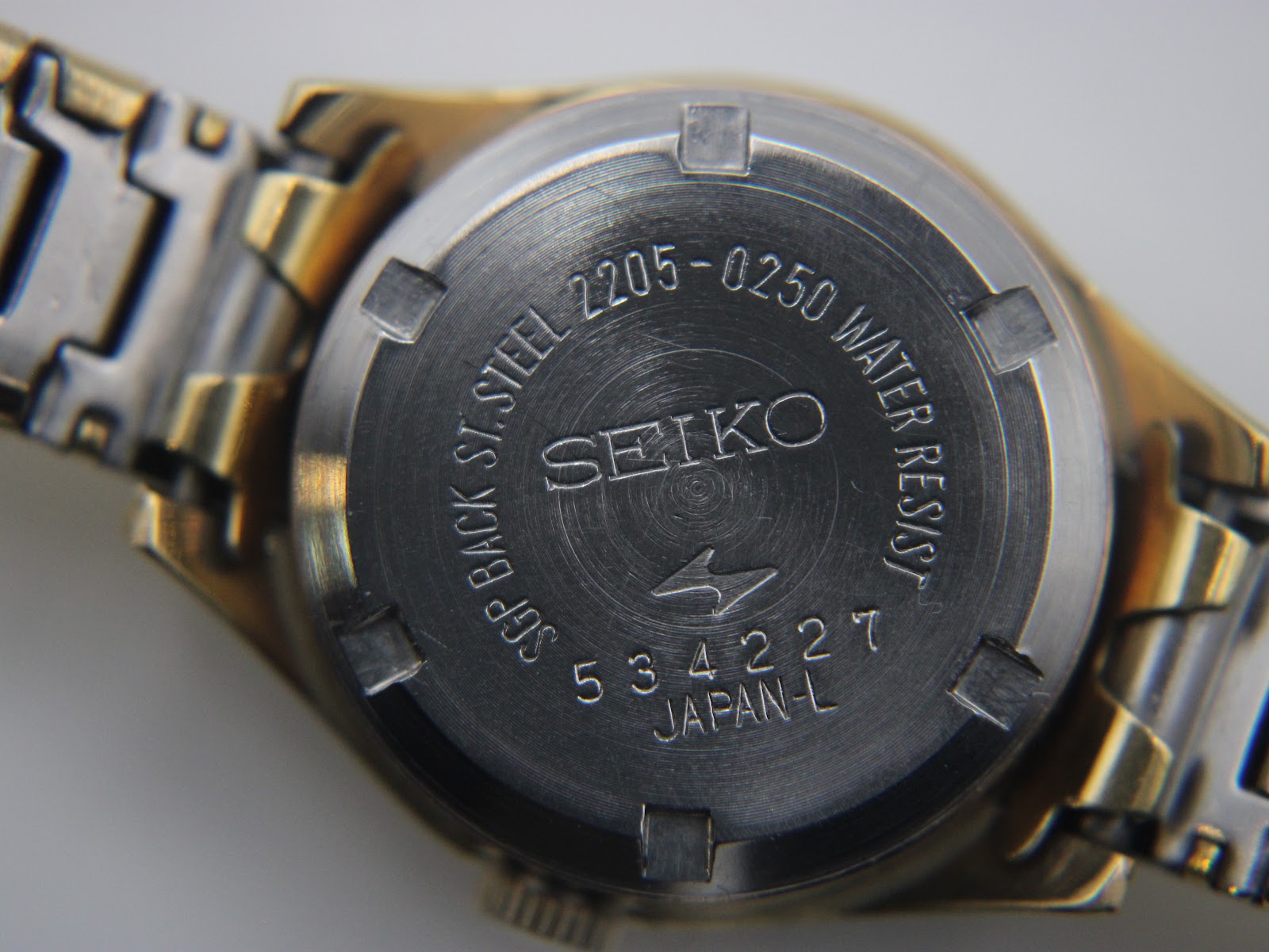 Close-up of the stainless steel case back with Seiko 2205-0250, serial number 534227, and Water Resist engraving.