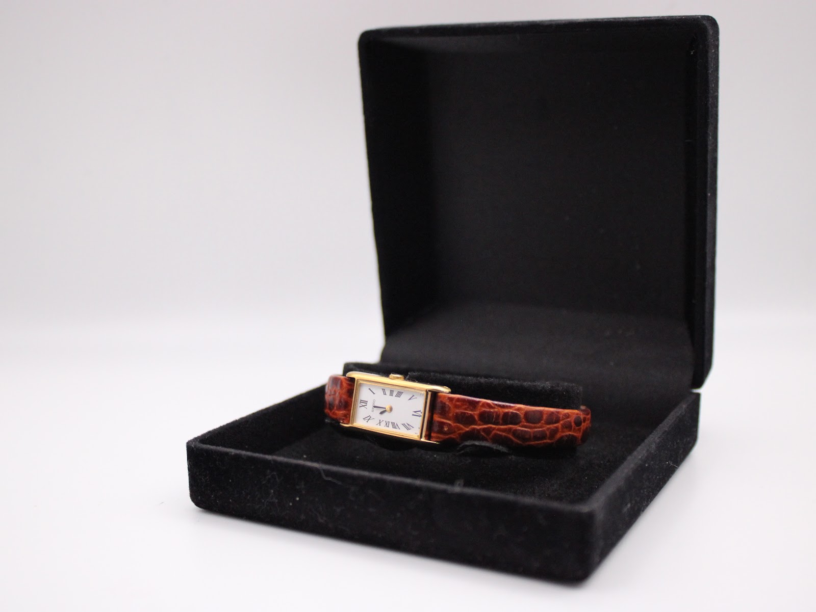 Seiko 2E20-6120 watch presented inside an open black unbranded velvet-lined display box, ready for presentation.