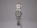 Front view of the Seiko 2N0372 ladies hand-wind watch on a clear stand, showing the rectangular silver-tone textured case and integrated bracelet.