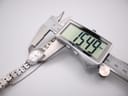 Digital caliper measuring the case diameter of the watch, displaying a precise reading of 15.49mm.