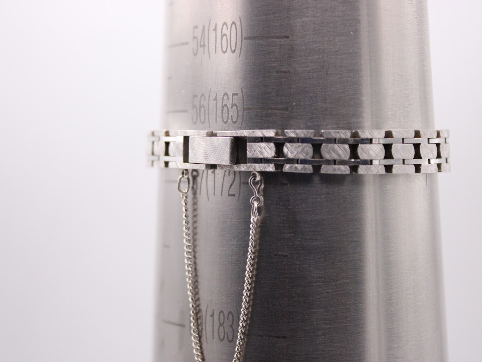 The watch bracelet measured on a wrist sizing gauge, showing a circumference of approximately 160mm. A safety chain is also visible.