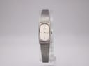 Front view of the Seiko 1320-6060 quartz watch with rectangular silver dial and integrated mesh bracelet on a clear stand.