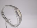 Another angled view of the Seiko watch on a display stand, highlighting the integrated bracelet design.