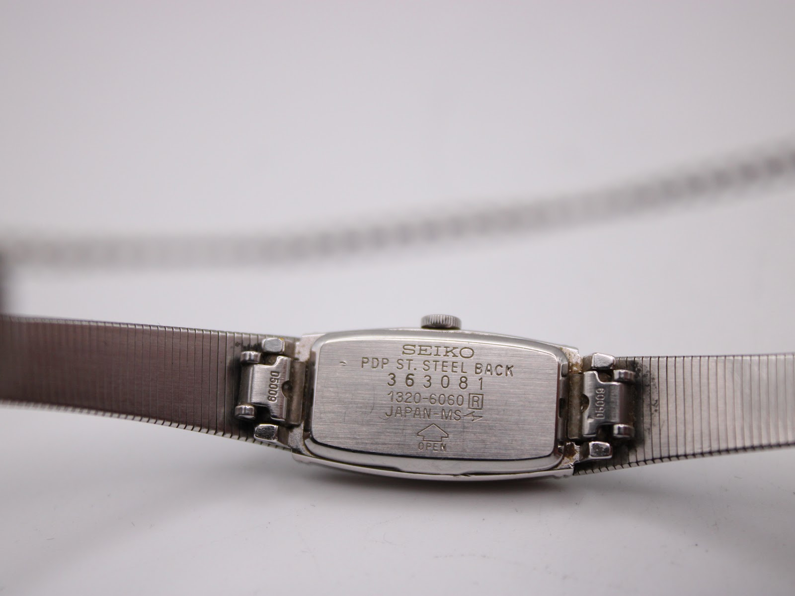 Close-up of the watch case back showing "SEIKO PDP ST. STEEL BACK 363081 1320-6060 R JAPAN-M-S" engravings.