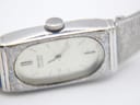 Detailed close-up of the watch dial, showing "SEIKO QUARTZ" text, baton indices, and minor crystal wear.