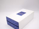 Outer white cardboard box for the Seiko watch, with a blue cutout revealing the "SEIKO" logo.