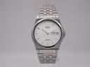 Seiko SQ 100 quartz watch front view showing white dial, polished baton indices, and stainless steel bracelet