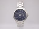Front view of Seiko 6N42-00E0 with deep navy blue dial, applied baton indices, dauphine hands and date window at 3 o'clock on stainless steel bracelet