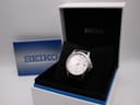 Side profile of Seiko stainless steel case showing polished bezel, brushed lug tops, and knurled crown at 3 o'clock