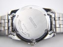 Close-up of the brushed stainless steel case back with Seiko logo, serial number '512514', and 'water resistant' engraving