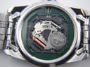 Close-up of the Seiko 7N43C quartz movement inside the case, showing the Renata 371 battery and one jewel