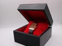 The Seiko watch presented inside its black original box with a red velvet interior.