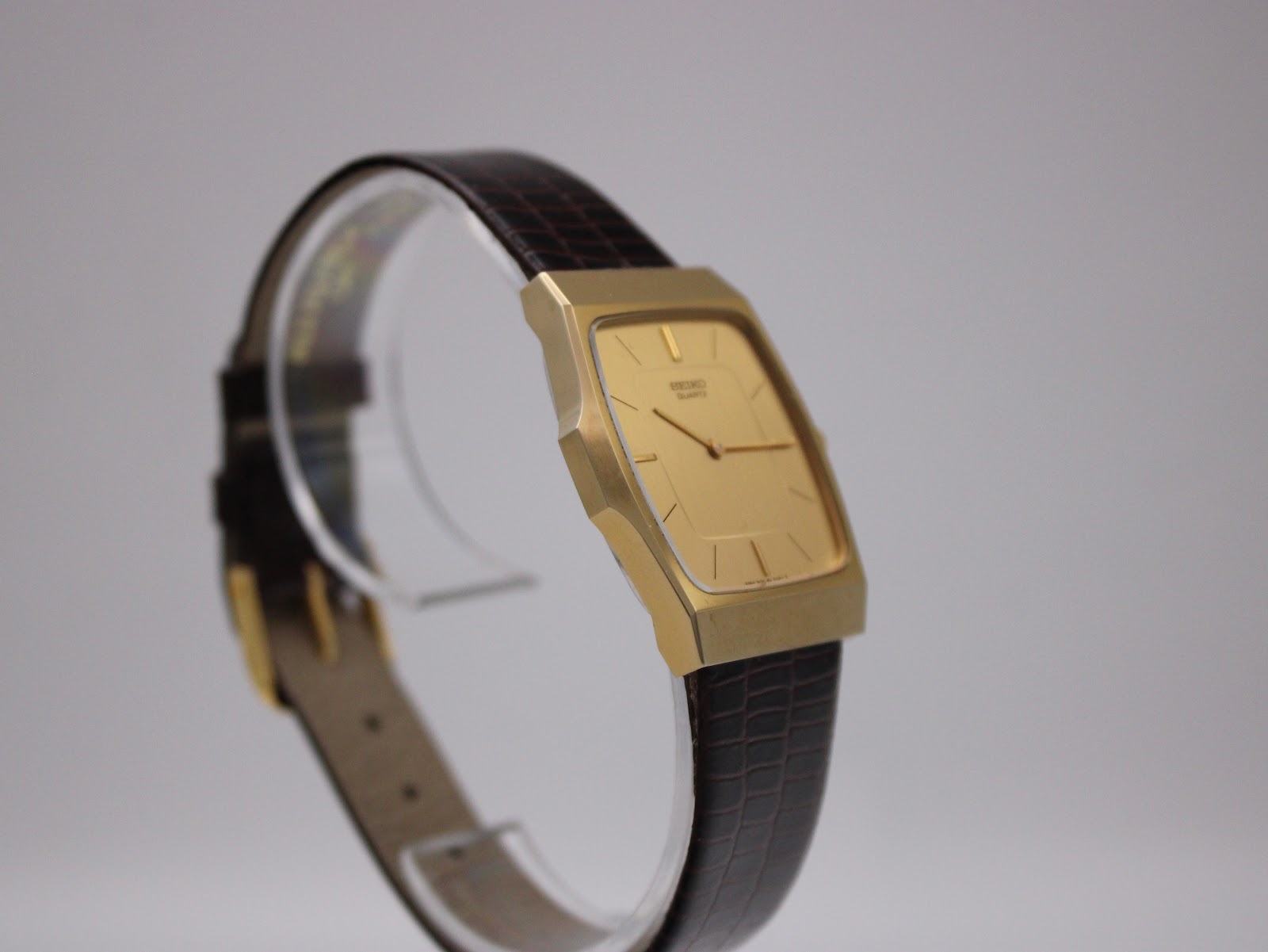 Another angled side view of the Seiko watch, highlighting the minimalist rectangular design.