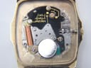Close-up of the Seiko 7430A quartz movement inside the open case, showing battery and internal components.