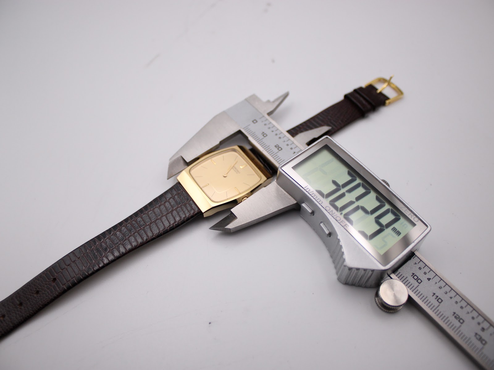 Digital caliper measuring the width of the Seiko watch case, showing 30.29mm.