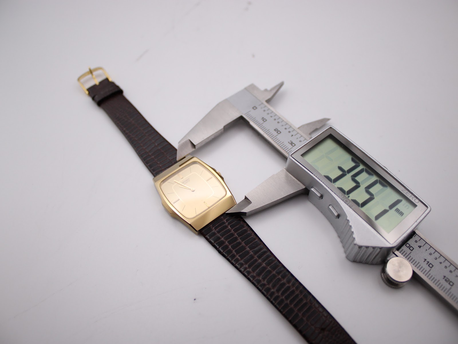Digital caliper measuring the length of the Seiko watch case, showing 35.51mm.