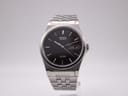 Front view of the Seiko SQ100 V743-8011 watch with black dial and stainless steel bracelet.