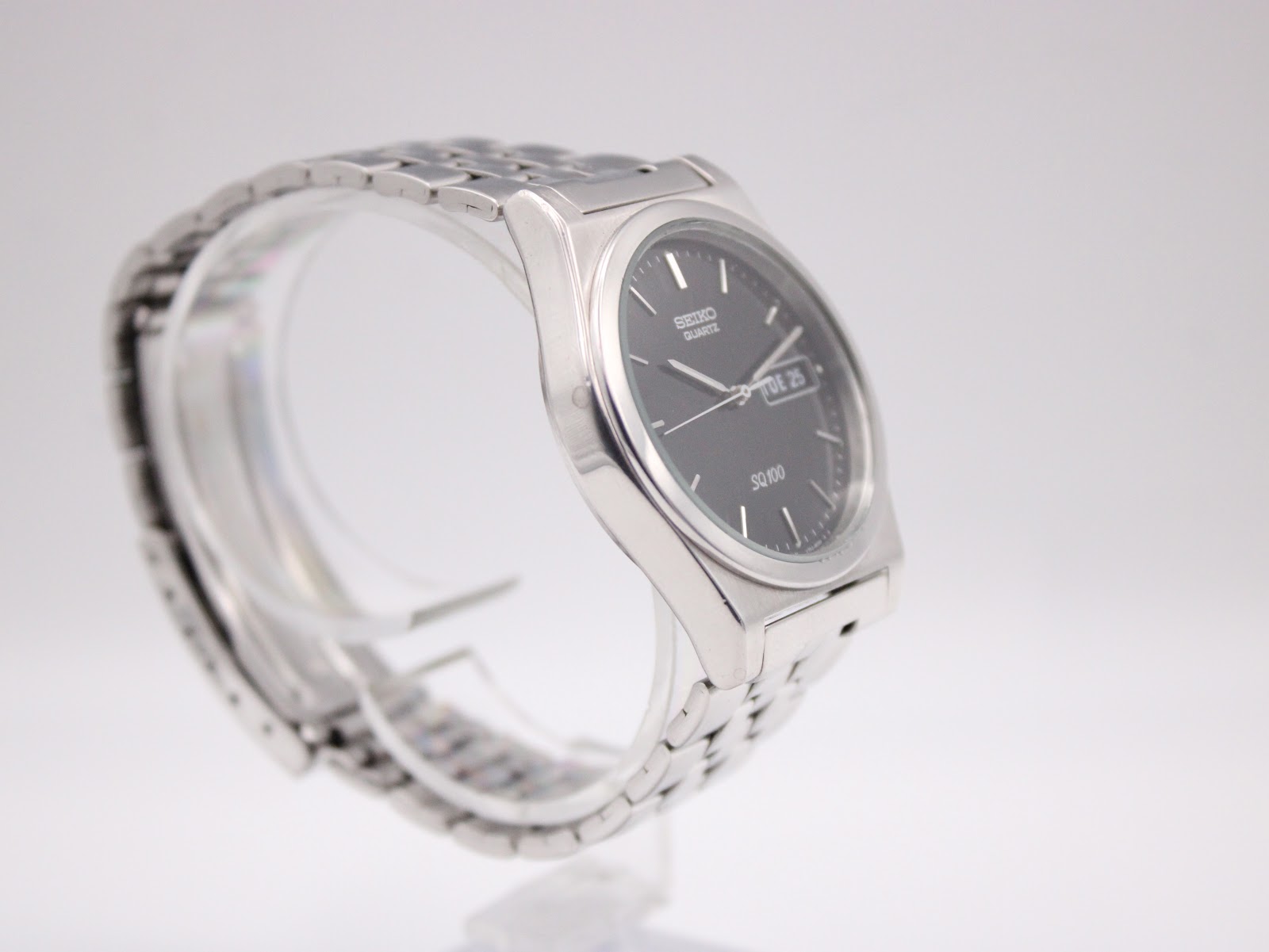 Another angled side view of the Seiko watch, highlighting the integrated bracelet.