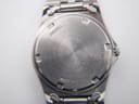 Close-up of the stainless steel case back showing model V743-8011 and serial 390220.