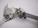 Digital caliper measuring the case diameter of the Seiko watch at precisely 35.25mm.
