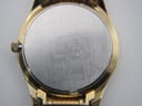 Close-up of the watch case back showing "SEIKO WATER RESISTANT BASE METAL ST.STEEL BACK 7N43-9011" and serial number.