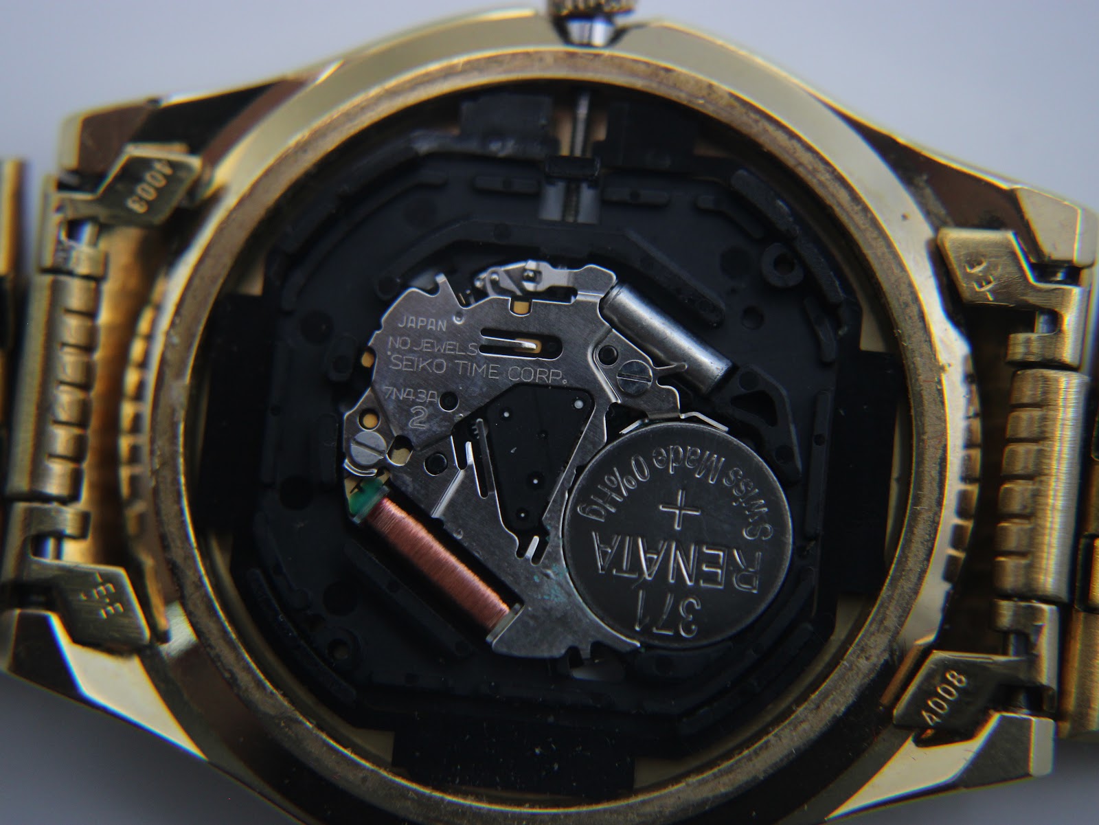 Interior view of the Seiko 7N43 quartz movement with a Renata battery and "JAPAN NO JEWELS SEIKO TIME CORP" markings.