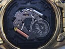 Extreme close-up of the Seiko 7N43C quartz movement with a Renata 371 battery installed, showing internal components.
