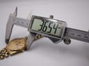 Digital caliper measuring the watch case diameter at 36.54mm, with the watch visible in the background.