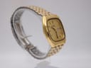 Another side-angle view of the gold Seiko watch, highlighting the case profile and bracelet links.