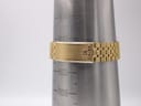 The gold-tone steel bracelet of the Seiko watch on a wrist sizing cone, indicating a maximum wrist fit of approximately 19.5cm.