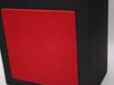 Close-up of the side of the black display box, featuring a red textured panel with an embossed 'SEIKO' logo.