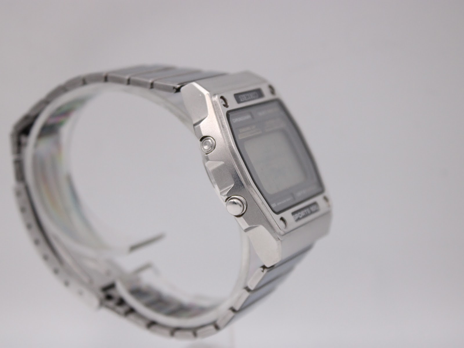 Left-side angle view of the Seiko A229-5060, showing the opposite set of pushers and the watch's profile.